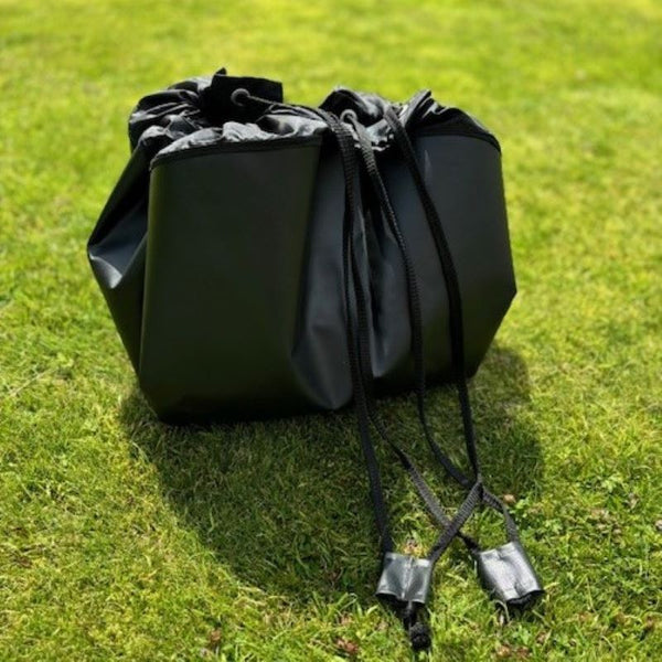 the changing mat with toggles pulled together to make the drawstring bag to hold you wet or dirty gear after a ride or swim