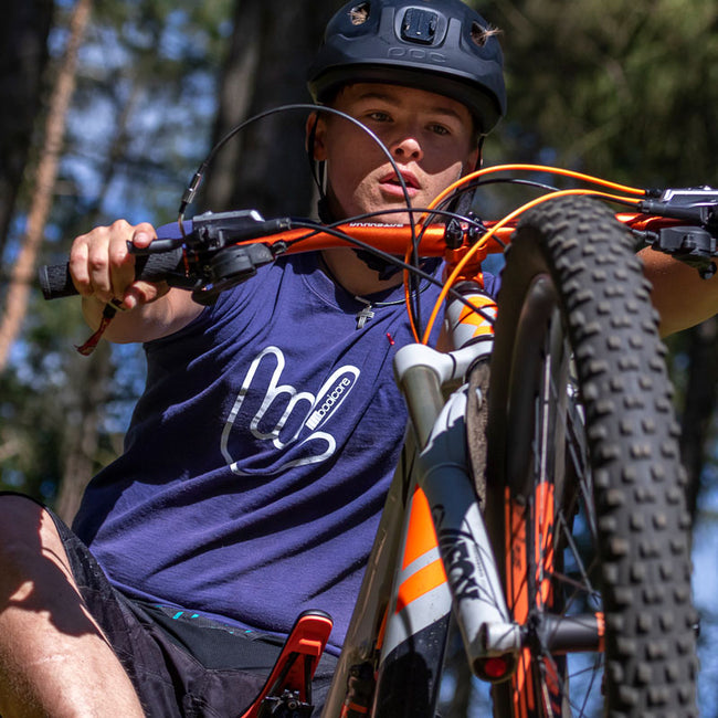 mountain biker wearing the navy booicore classic hand horn tee
