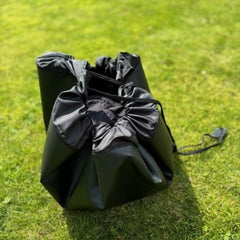 pull the toggles together making a drawstring bag change mat