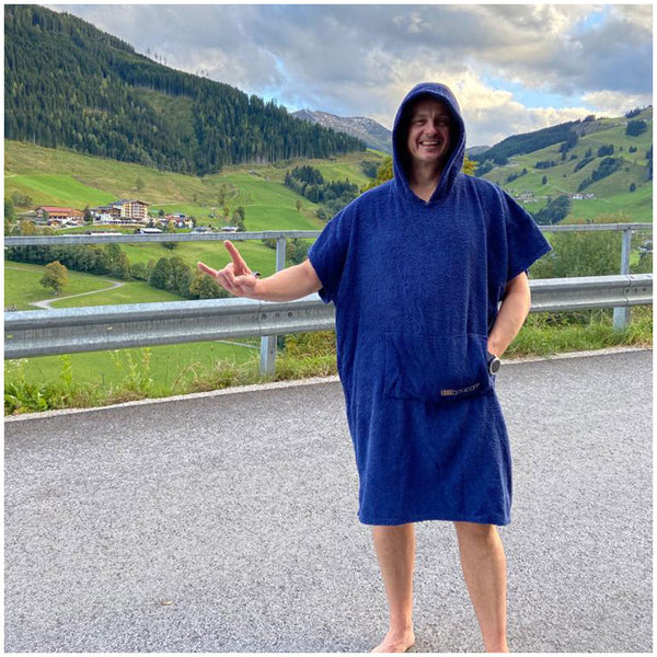 happy man in austrian mountains wearing a blue booicore cotton towelling change dry robe